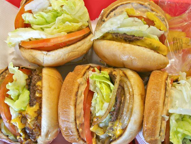 An overhead of five different types of In-N-Out burgers