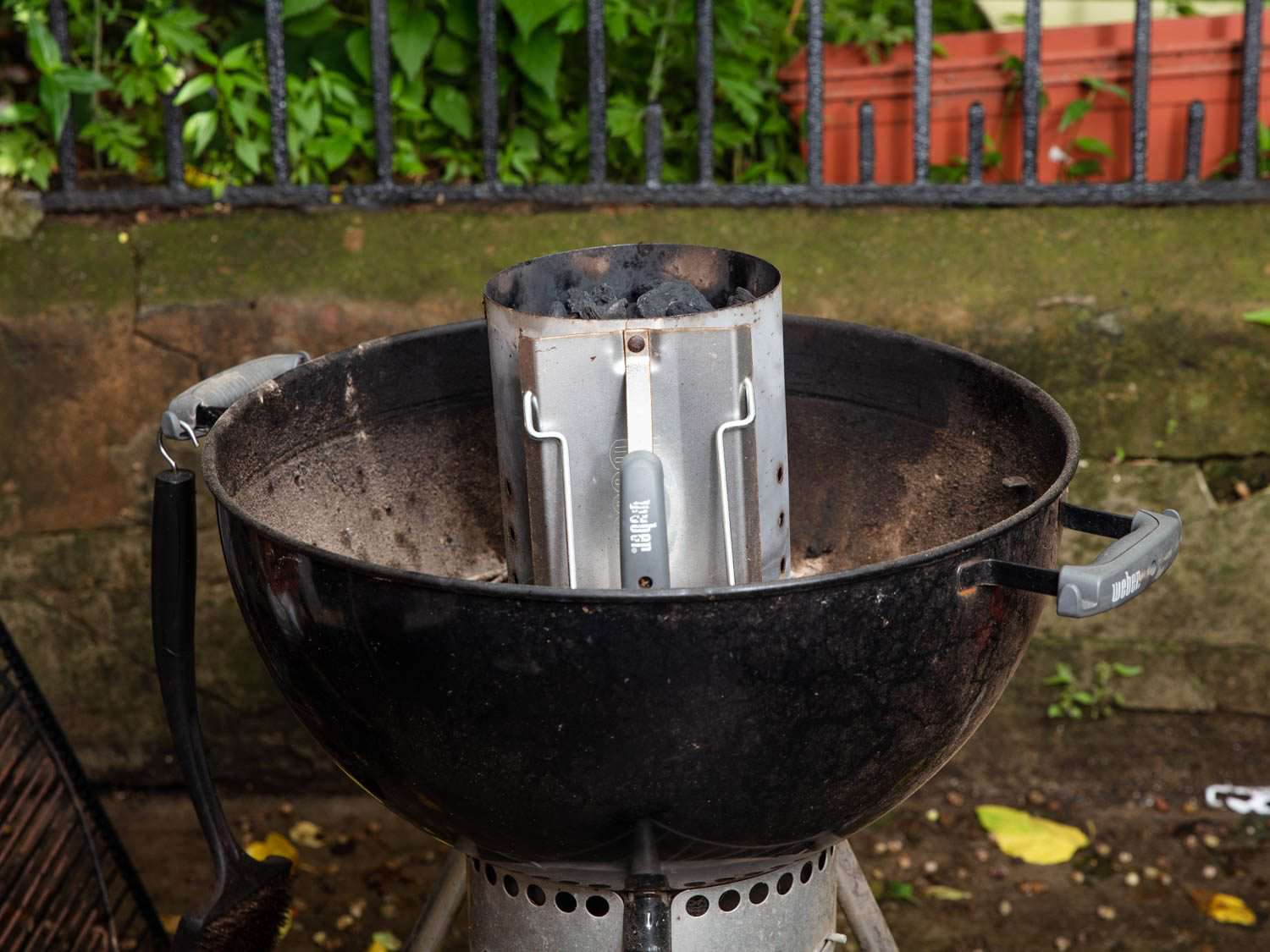 A chimney starter set inside a grill.