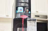 Ninja Thirsti Drink System dispensing a drink into a glass