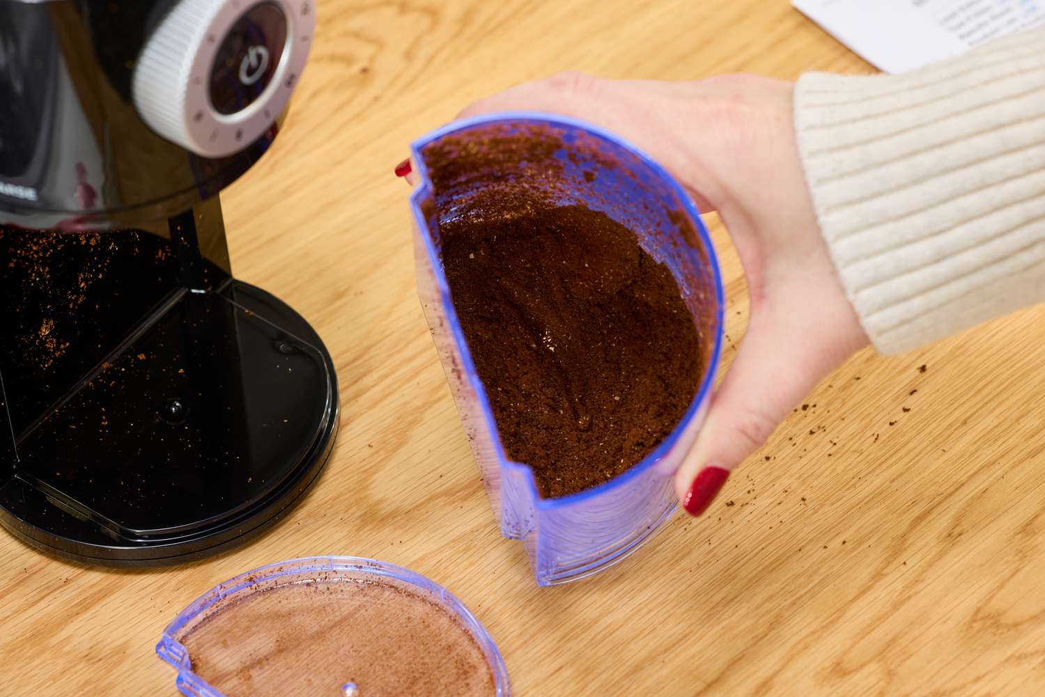 Person holding piece of Krups Precision Coffee Grinder