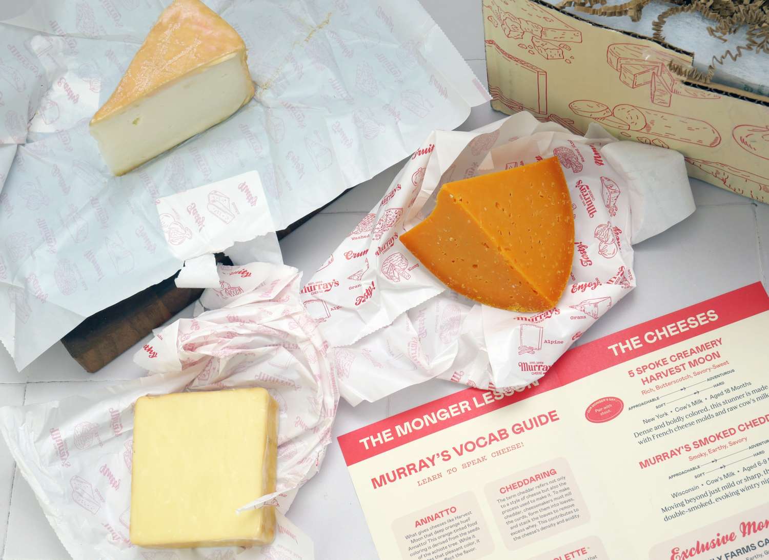 three cheeses on a white surface