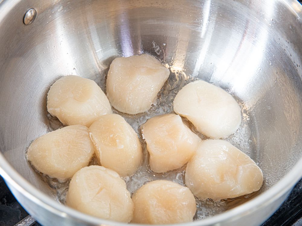 Overhead view of scallops in pan