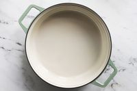 A round dish with handles placed on a white surface