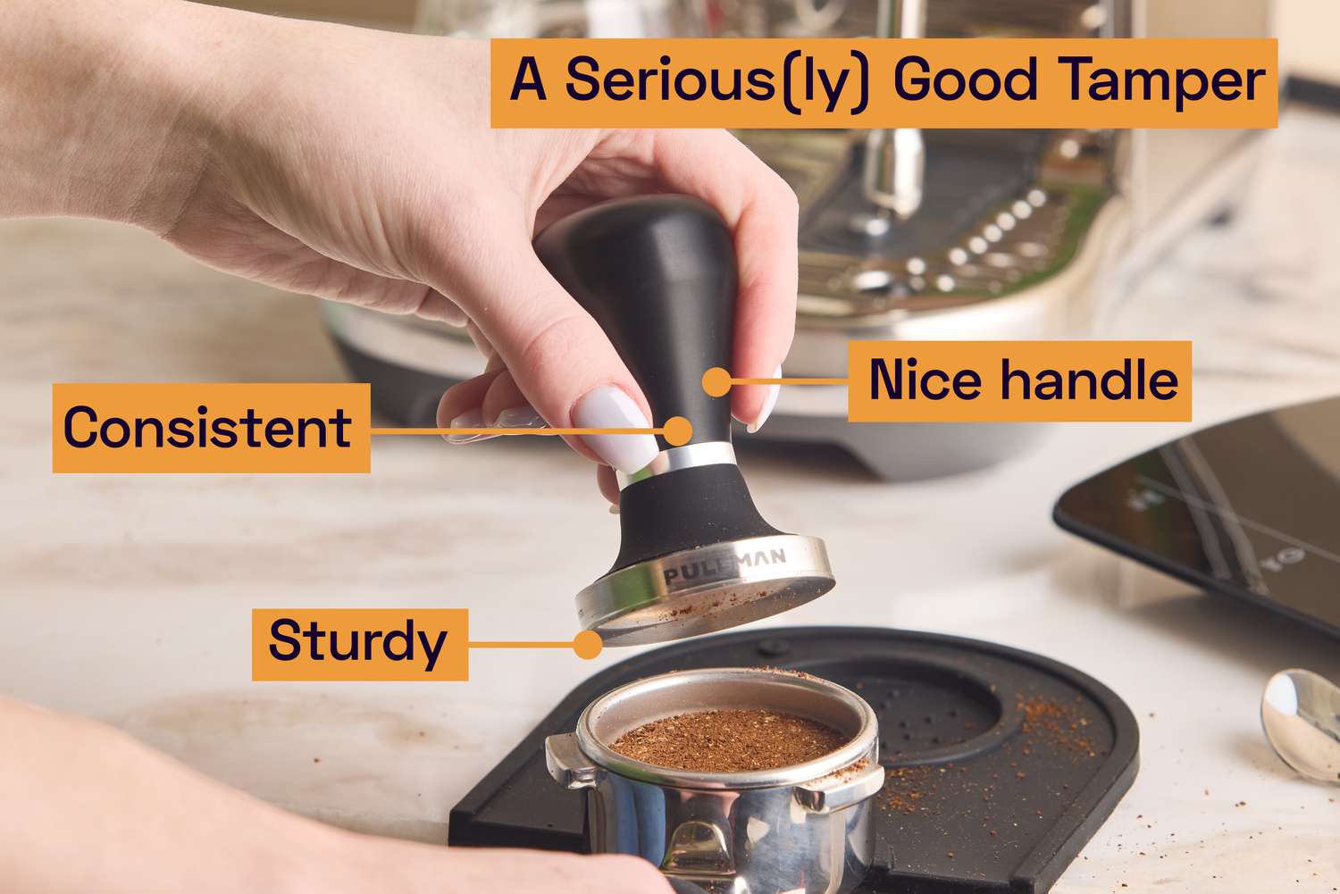 A person using a tamper to compact espresso grounds.