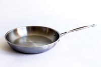 A pan from the Goldilocks 7-piece Cookware Set on a white surface