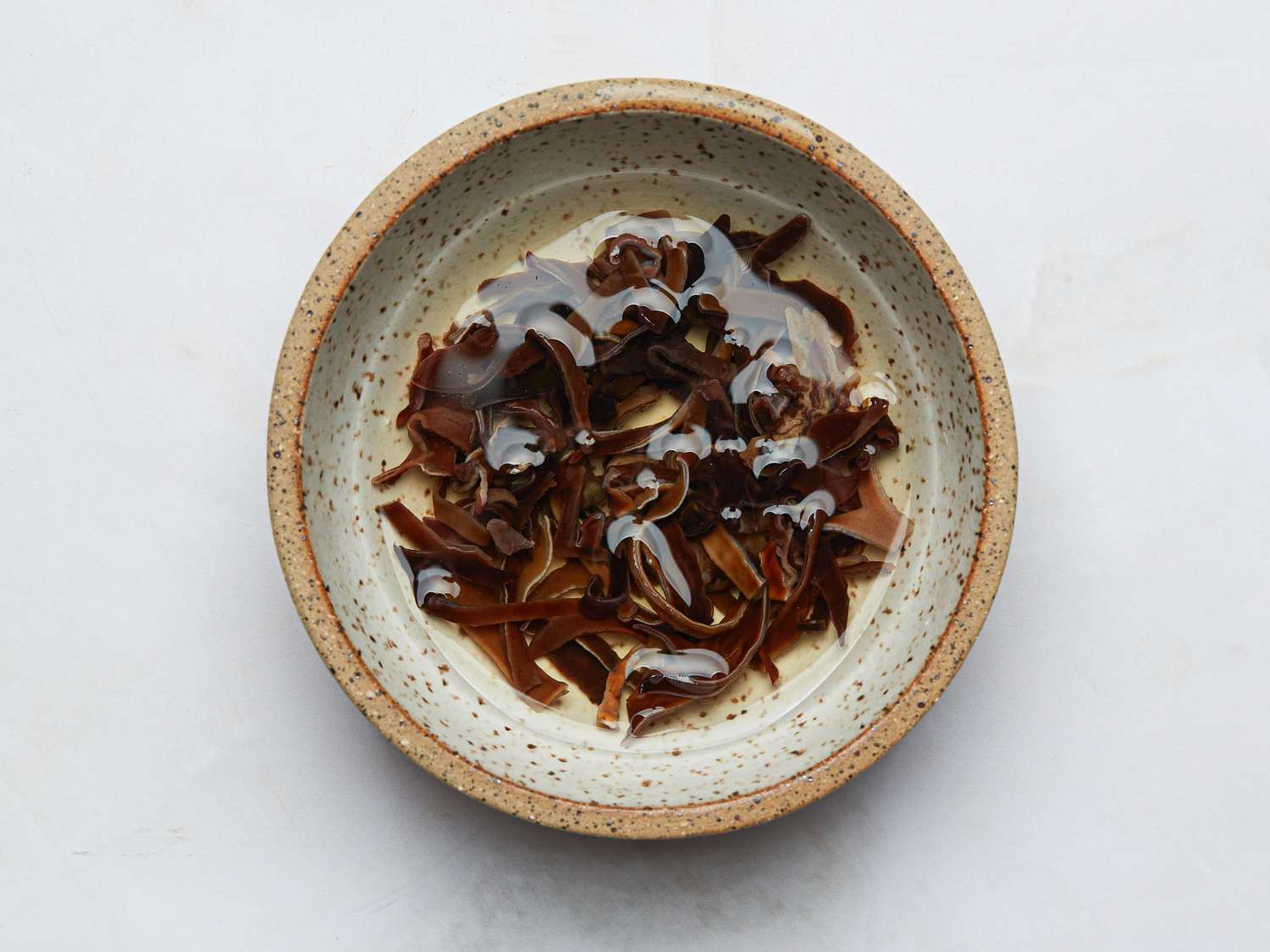 A bowl containing soaked wood ear mushrooms