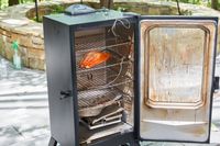 Salmon cooking inside the Masterbuilt MB20072918 40-Inch Digital Electric Smoker