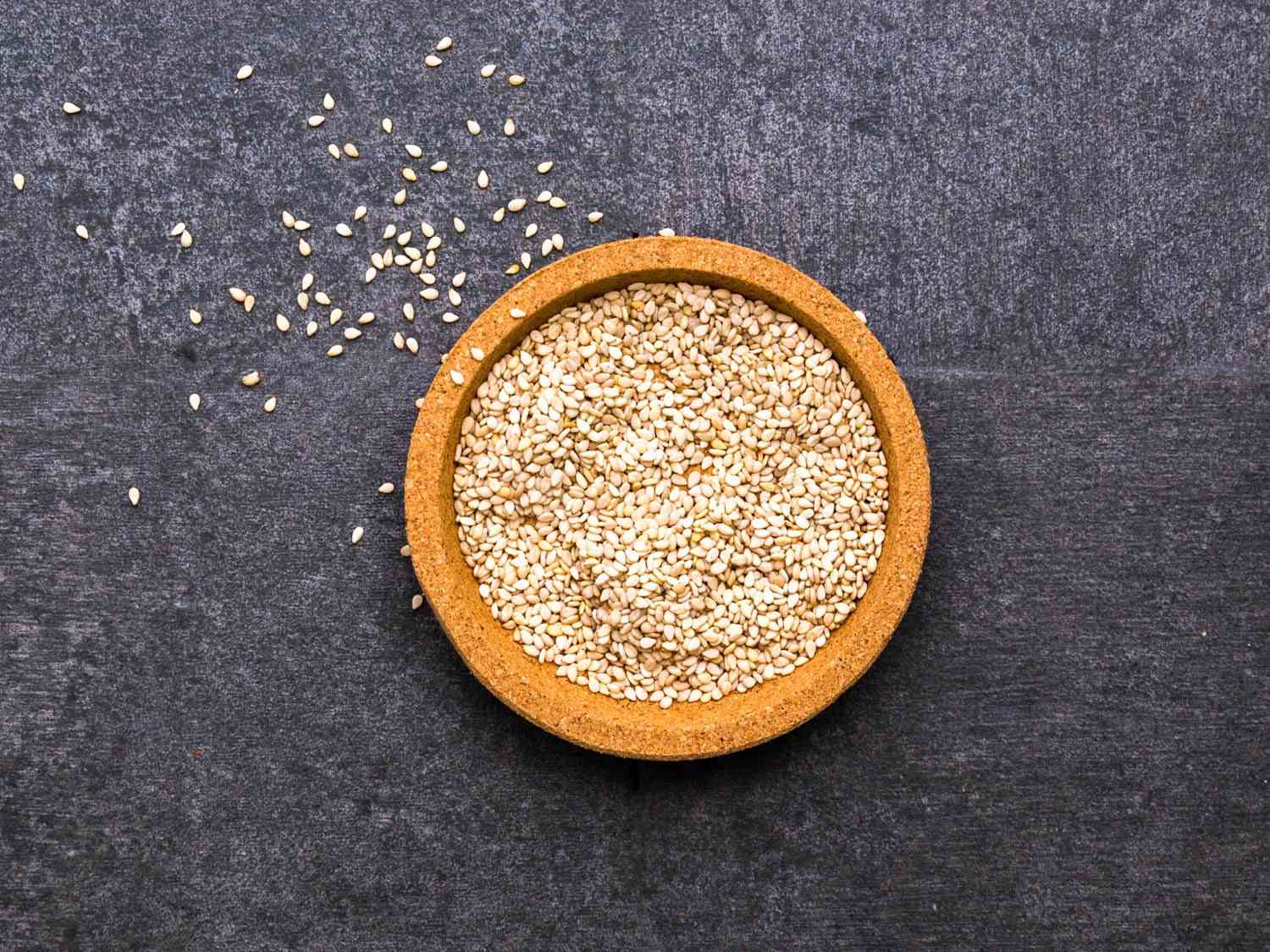A closeup of toasted sesame seeds in a ramekin.