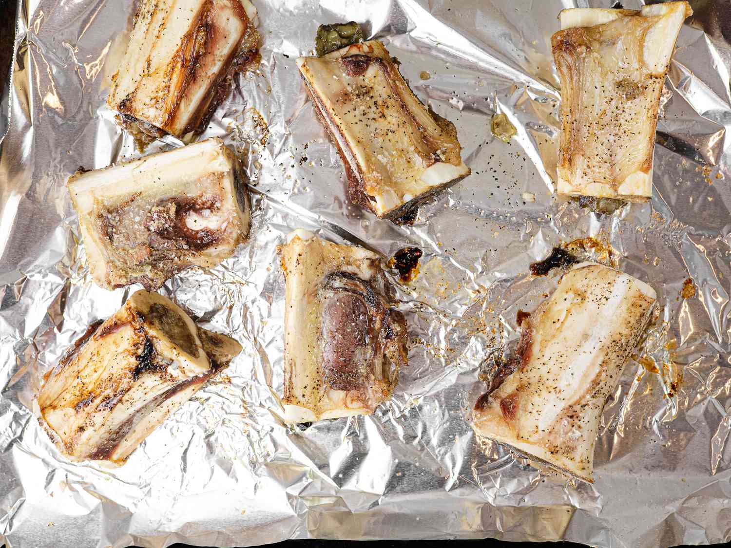 Roasted marrow bones on a foil lined baking sheet