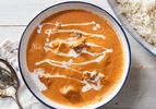 Butter chicken in a white bowl