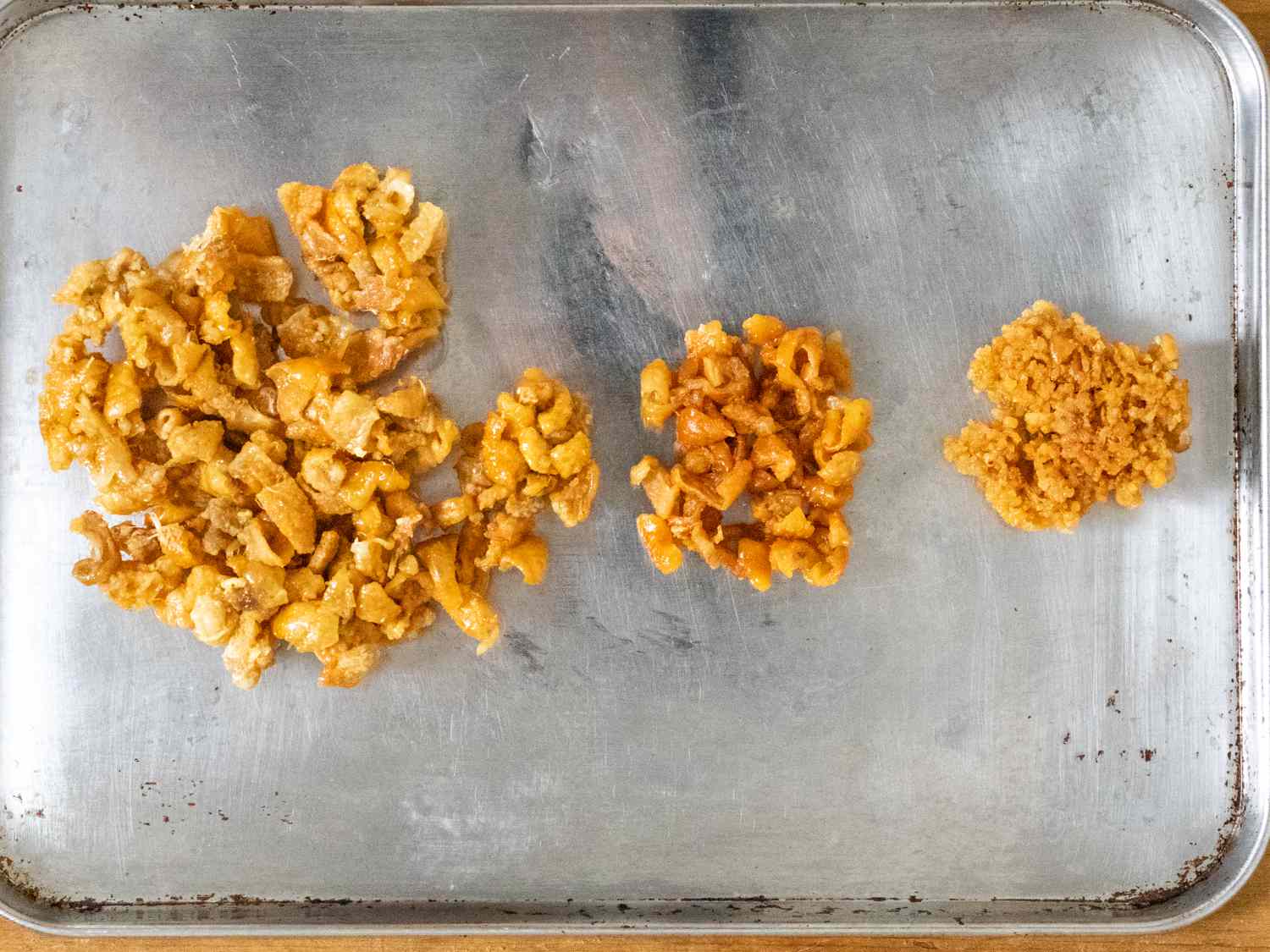 Three different chicken skin chips, produced by cutting the skin up in different ways and microwaving it.