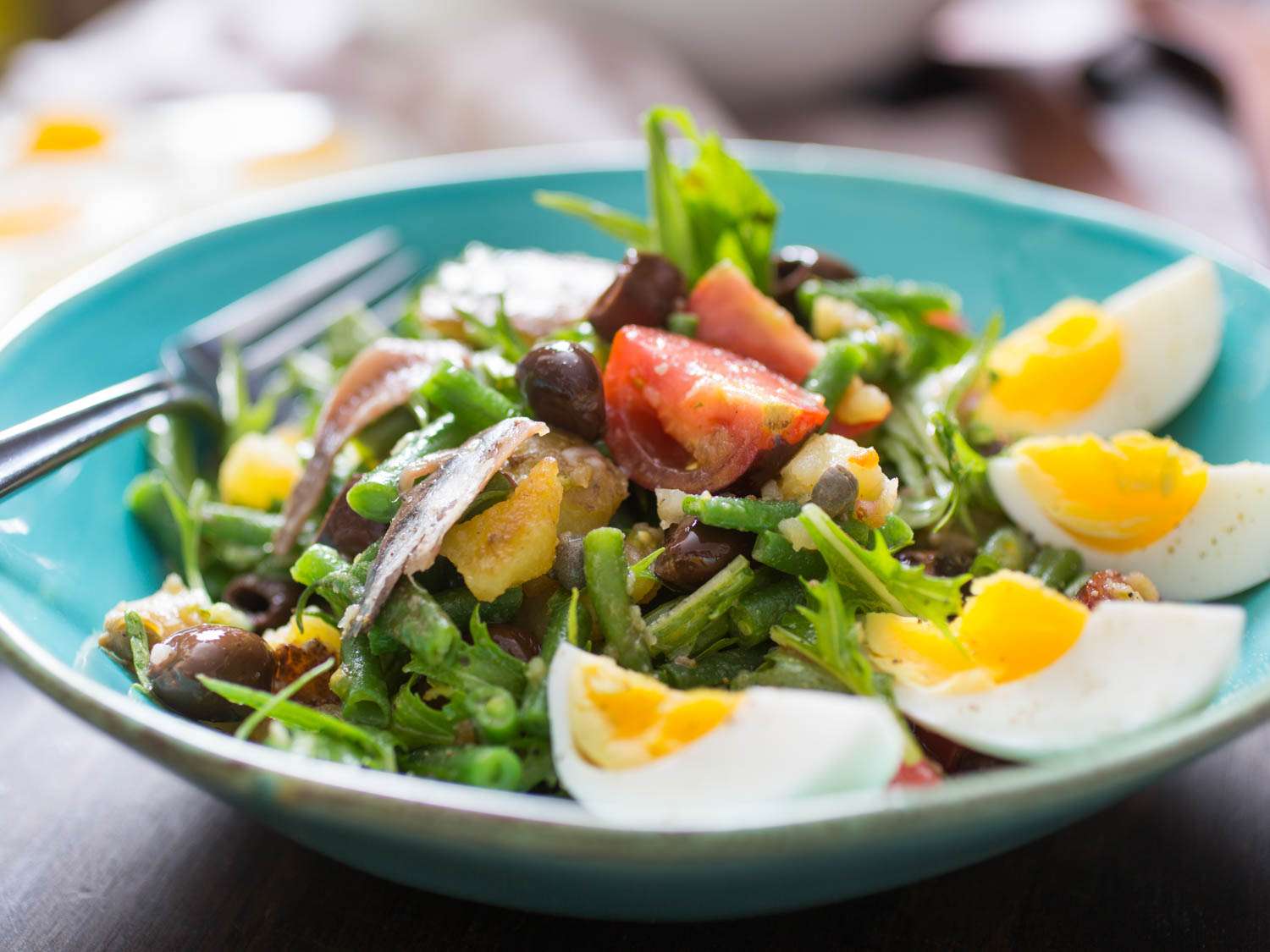 Closeup of an un-composed Niçoise salad.