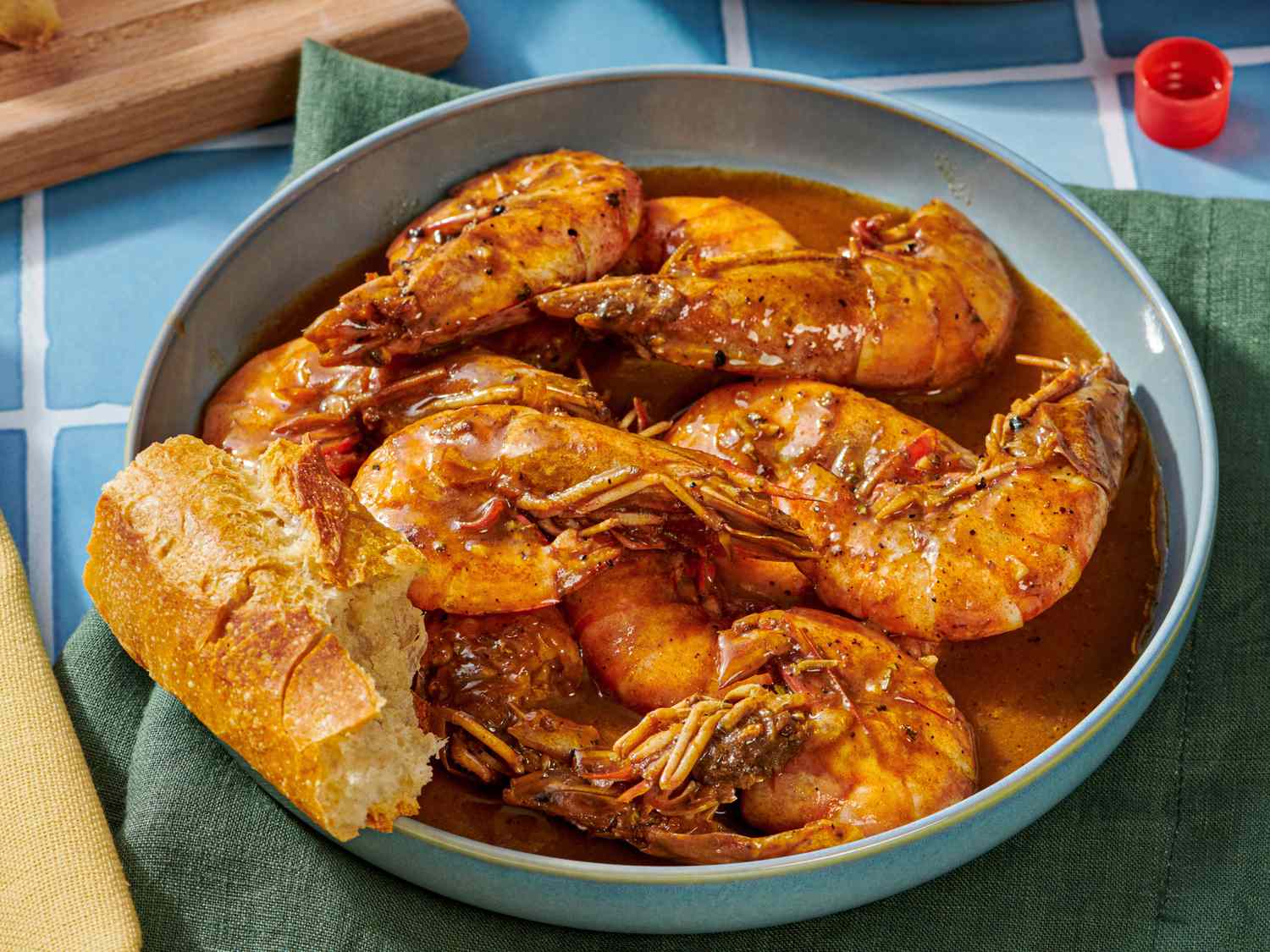 A bowl of New Orleans barbecue shrimp with crusty bread