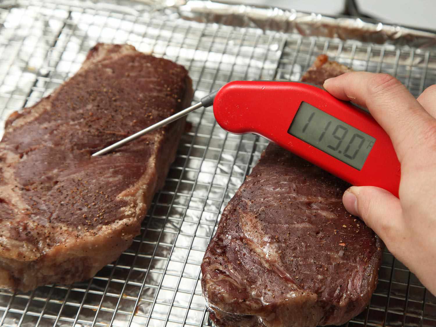 steak on rimmed baking sheet with rack