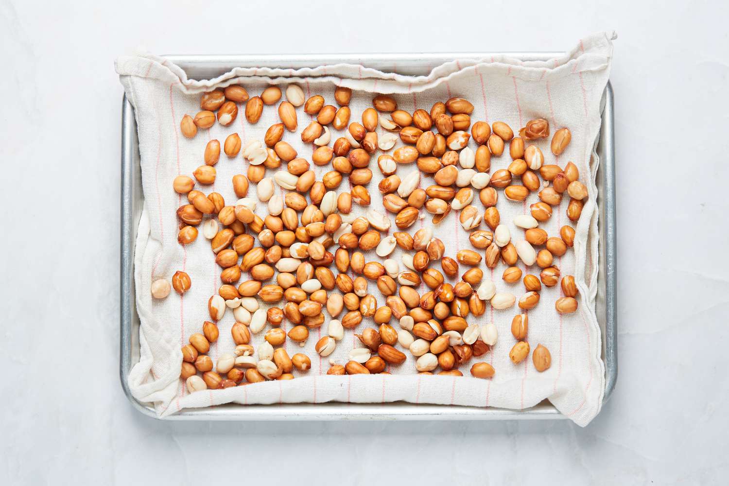 Overhead view of peanuts on rimmed backing sheet