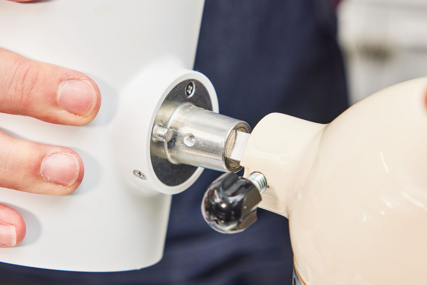 The KitchenAid shaved ice maker being attached to a stand mixer.