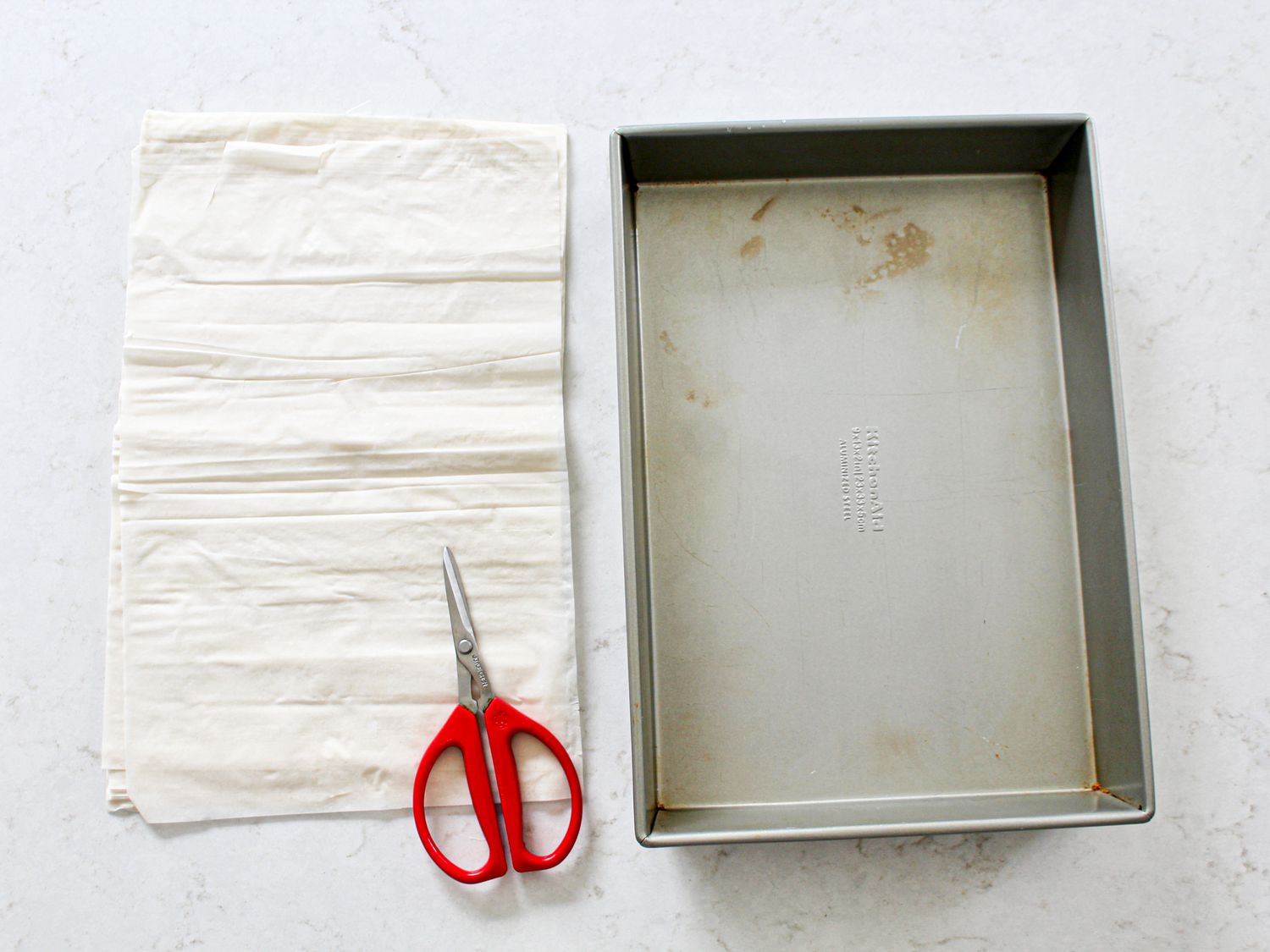 Cut phyllo sheets next to baking pan