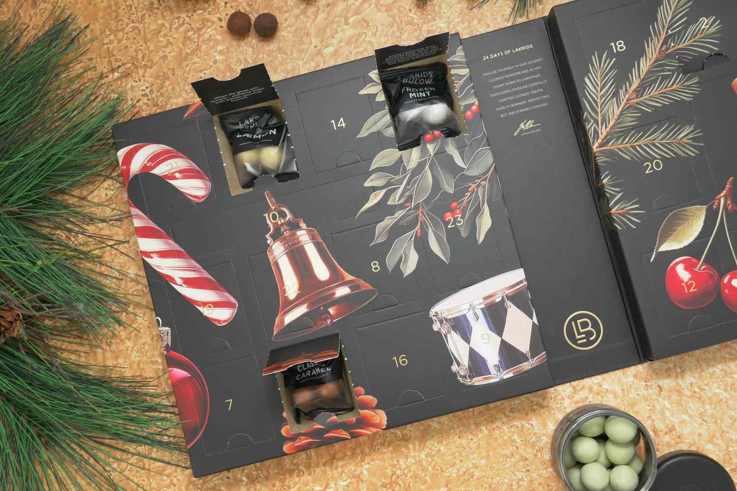 A licorice advent calendar with opened compartments displaying candies decorated with festive illustrations