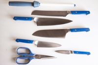 Misen 7-piece kitchen knife set with a sharpener and scissors arranged on a white surface