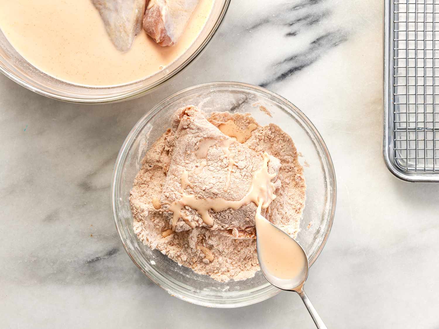 Drizzling brine over chicken for frying in air fryer