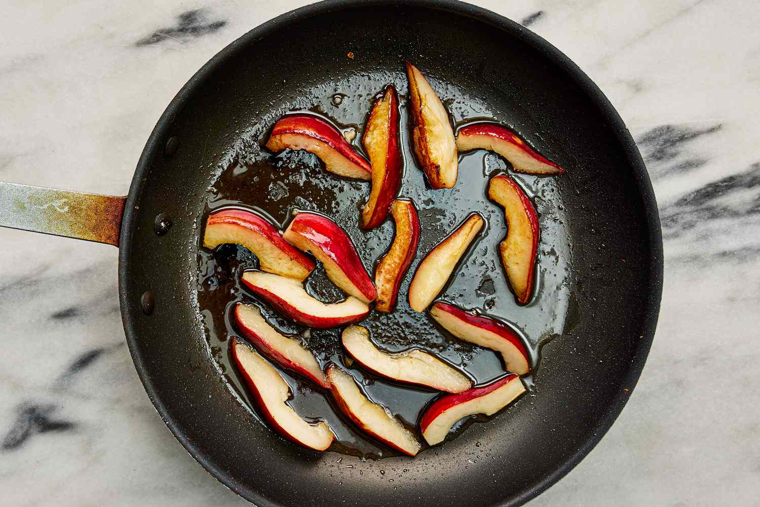 Overhead view of searing peaches