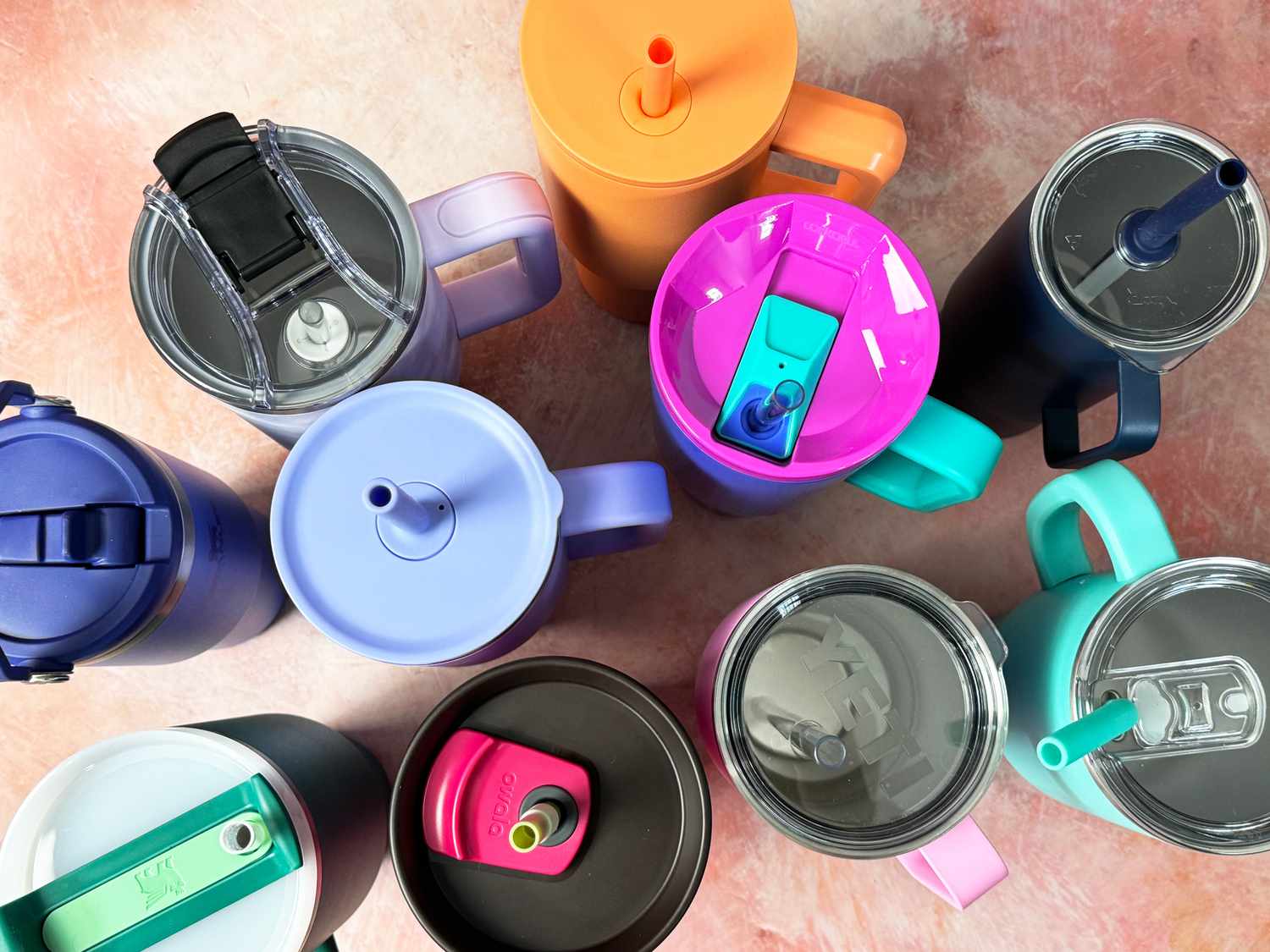 A group of empty insulated empty tumblers with their lids on.