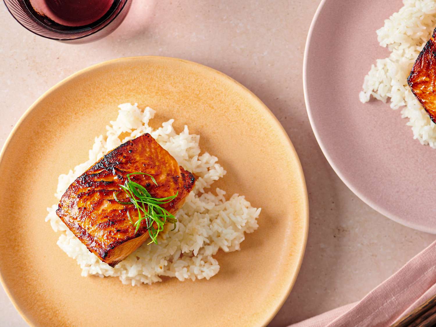 Miso glazed salmon served over white rice on a plate
