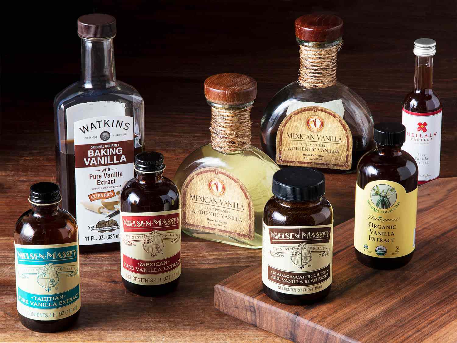 several bottles of vanilla extract on a wooden surface