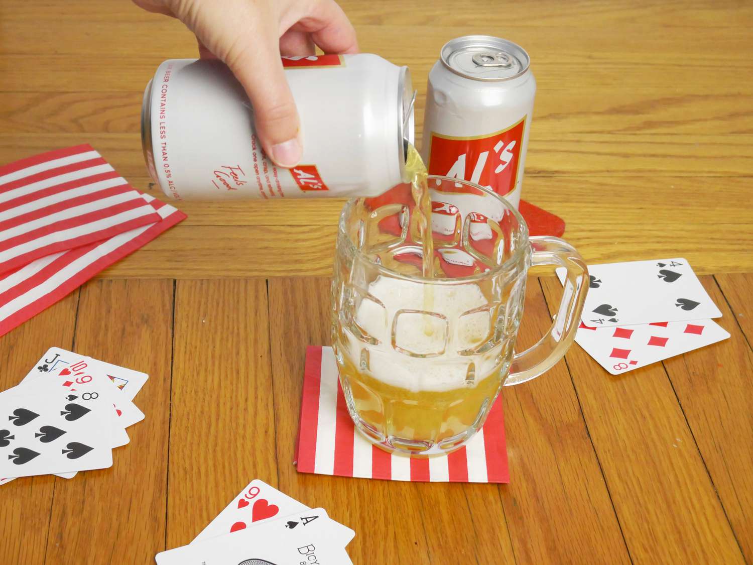 a person pouring a can of Al's into a glass