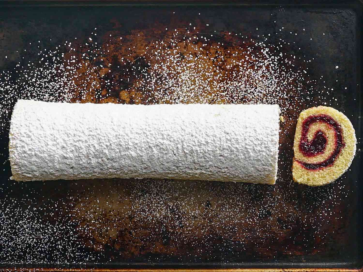 Overhead shot of a sliced jelly roll dusted in powdered sugar