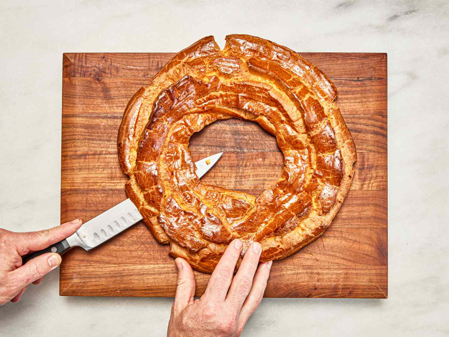 Overhead view of cutting choux pastry in half
