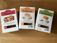 Three boxes of Boarderie-branded crackers on a wooden surface