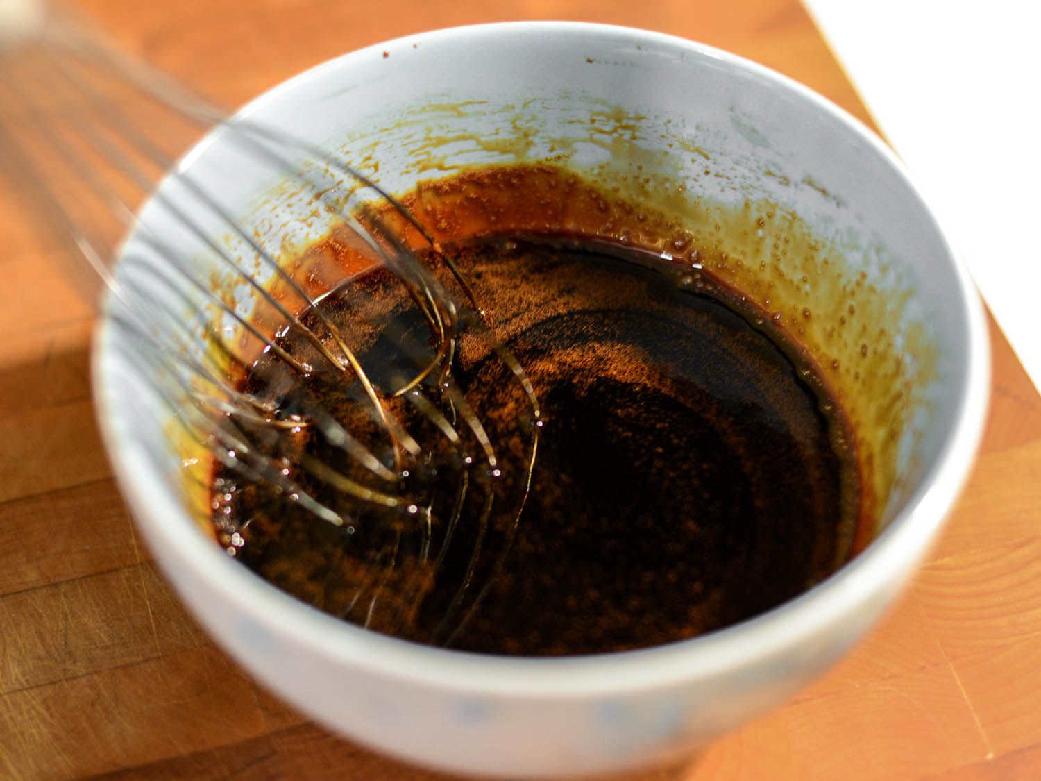 Whisking all of the ingredients for the dipping sauce in a small bowl.