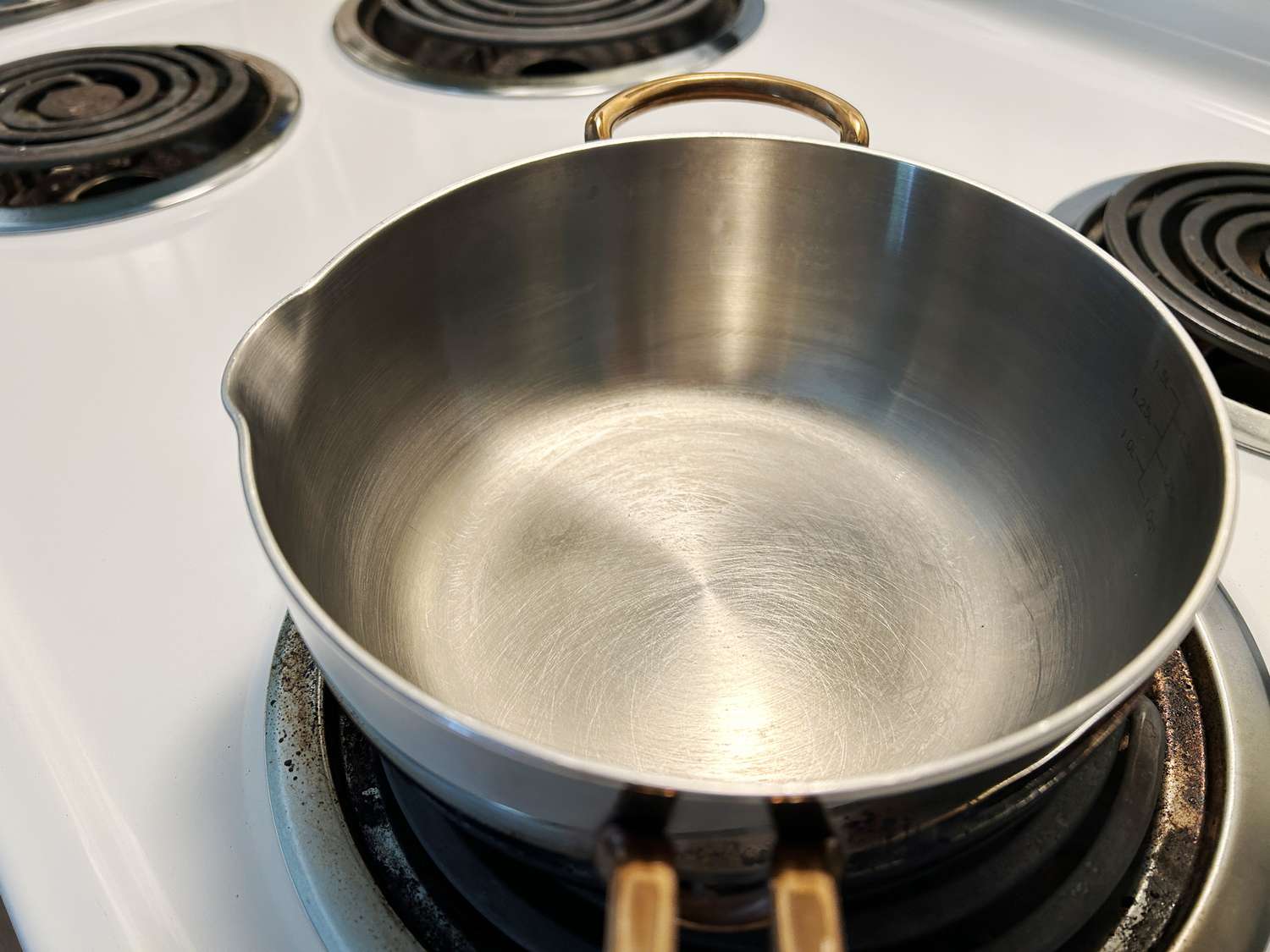 A closeup of the pour spout and interior of the Great Jones Little Saucy saucier