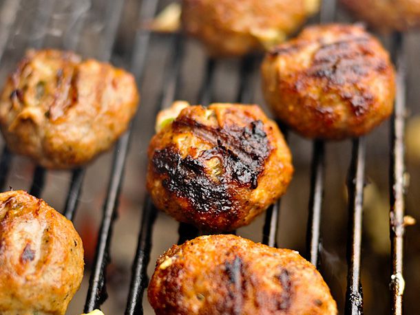 Armadillo eggs charring on a grill.