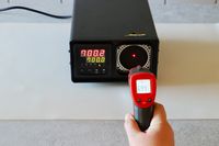 A person callibrating an infrared thermometer 