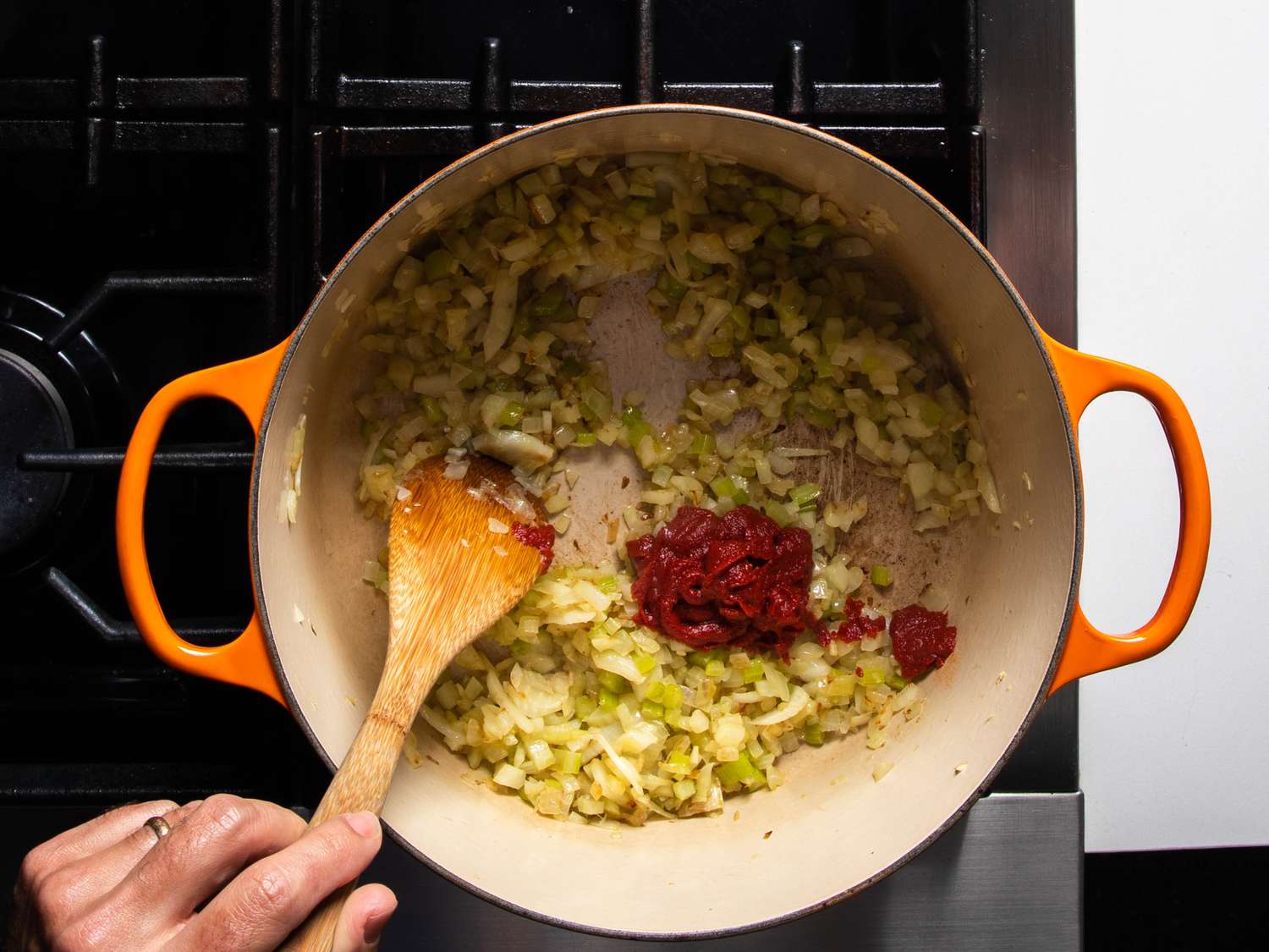Fennel and celery with tomato paste in the pot.