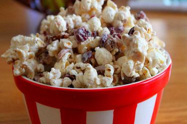 Cran apple white chocolate popcorn, served in a red and white bowl,