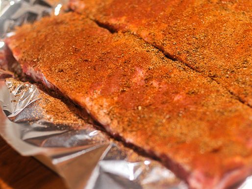 Closeup of the ribs, coated with the Cajun seasoning and ready to smoke.