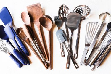 Four kitchen utensil sets displayed on a white background