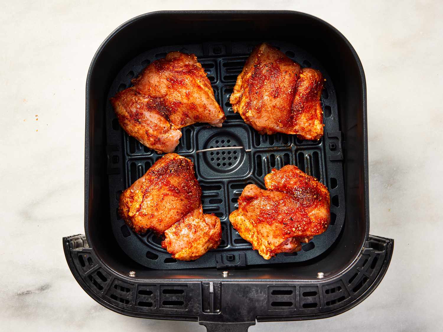 Overhead view of chicken in air fryer
