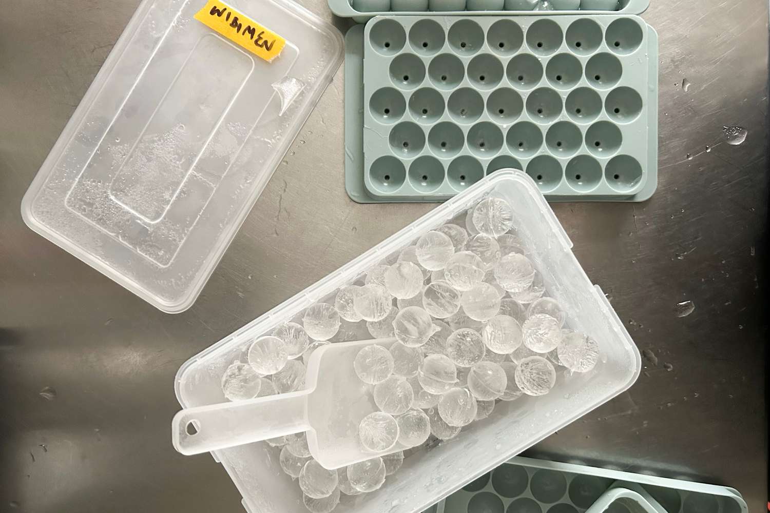 WIBIMEN Ice Cube Tray for Freezer with Lid & Bin on a table with round ice