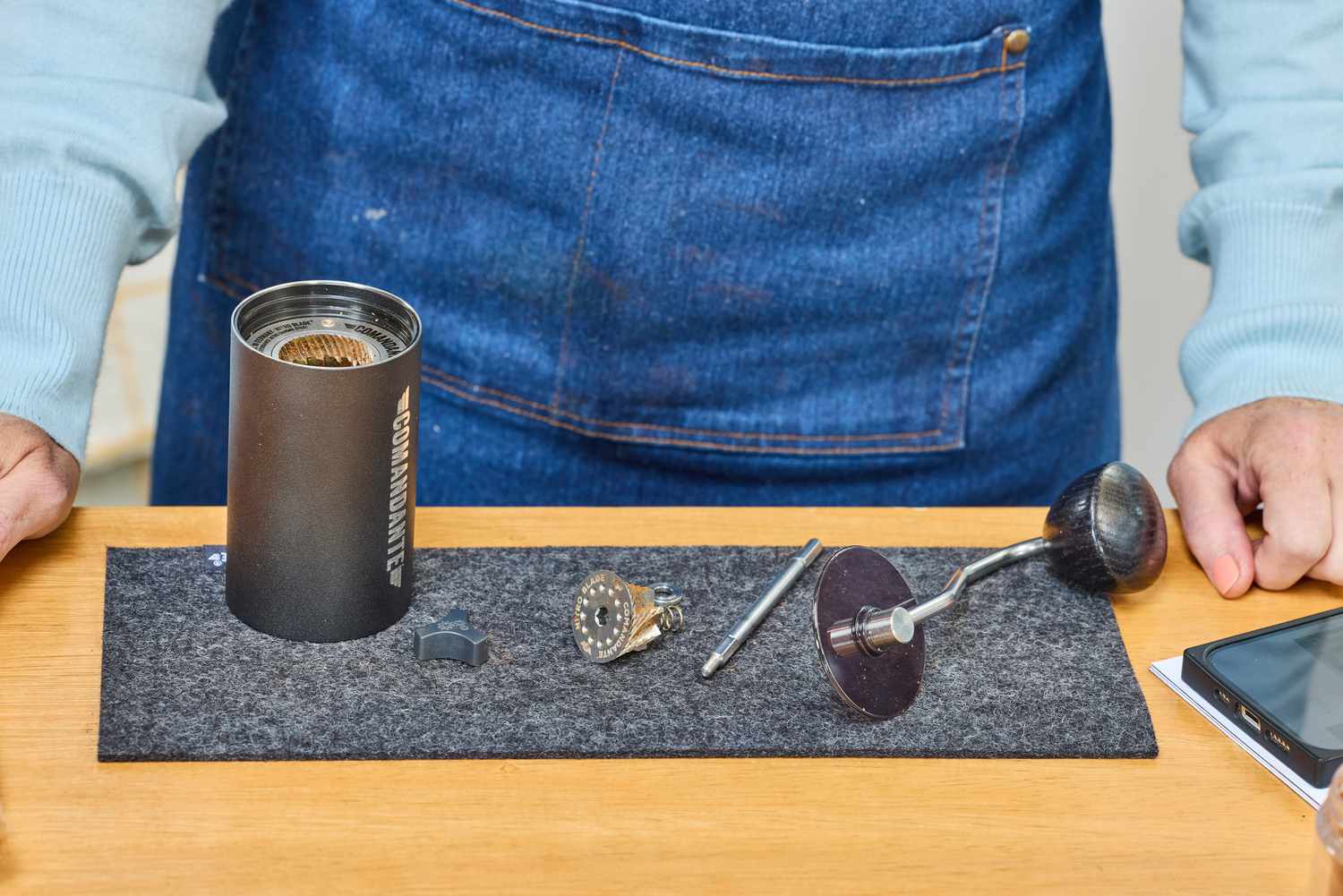 The parts of the Comandante C40 Nitro Blade Grinder on a mat