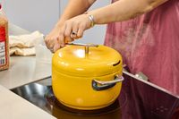 A person turns the crank on the top of the Popsmith The Popper