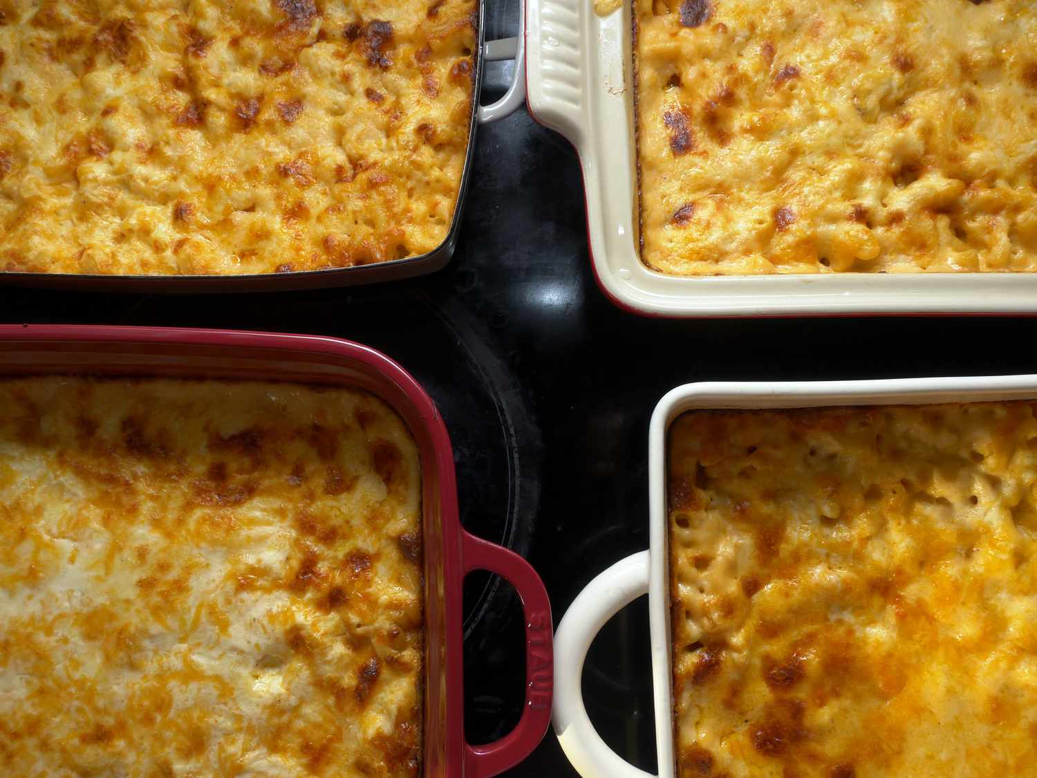 a closeup of four different dishes with baked macaroni and cheese, showcasing the different handles