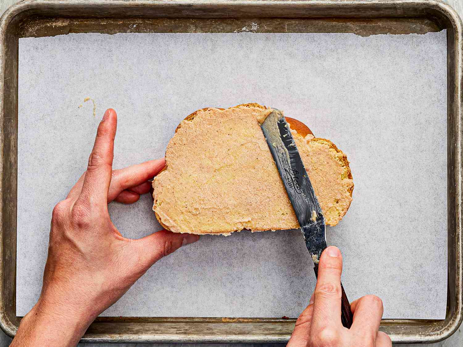 Overhead view of spreading toast with honey butter