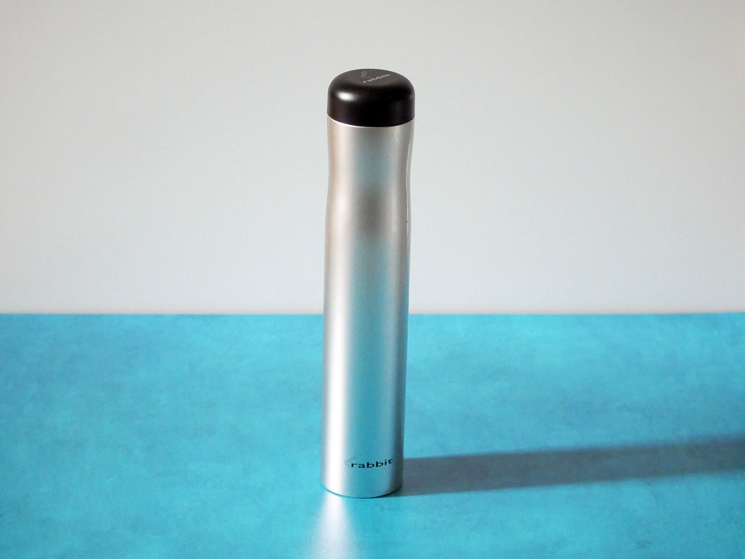 the rabbit electric corkscrew on a blue countertop