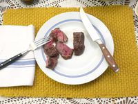 a plate of steak with the messermeister 