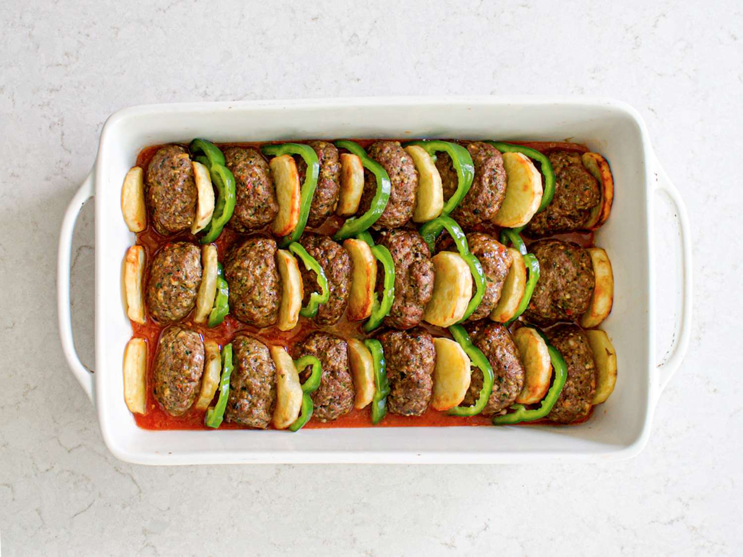 Uncooked kafta in baking dish