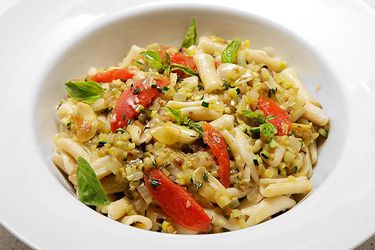 Summer ratatouille with pasta, served in a white porcelain bowl.